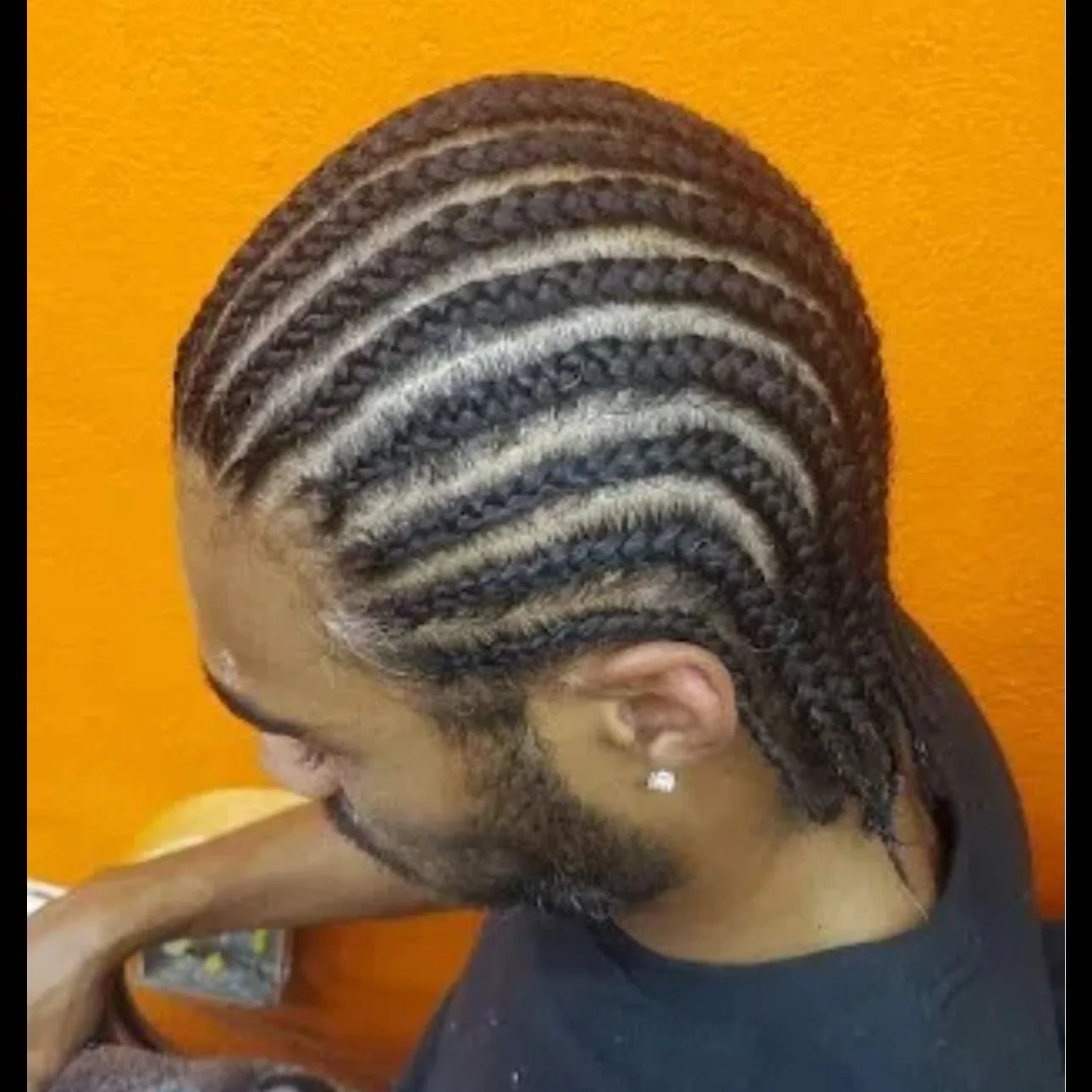 Kim's Hair Boutique client wearing men's straight-back cornrows