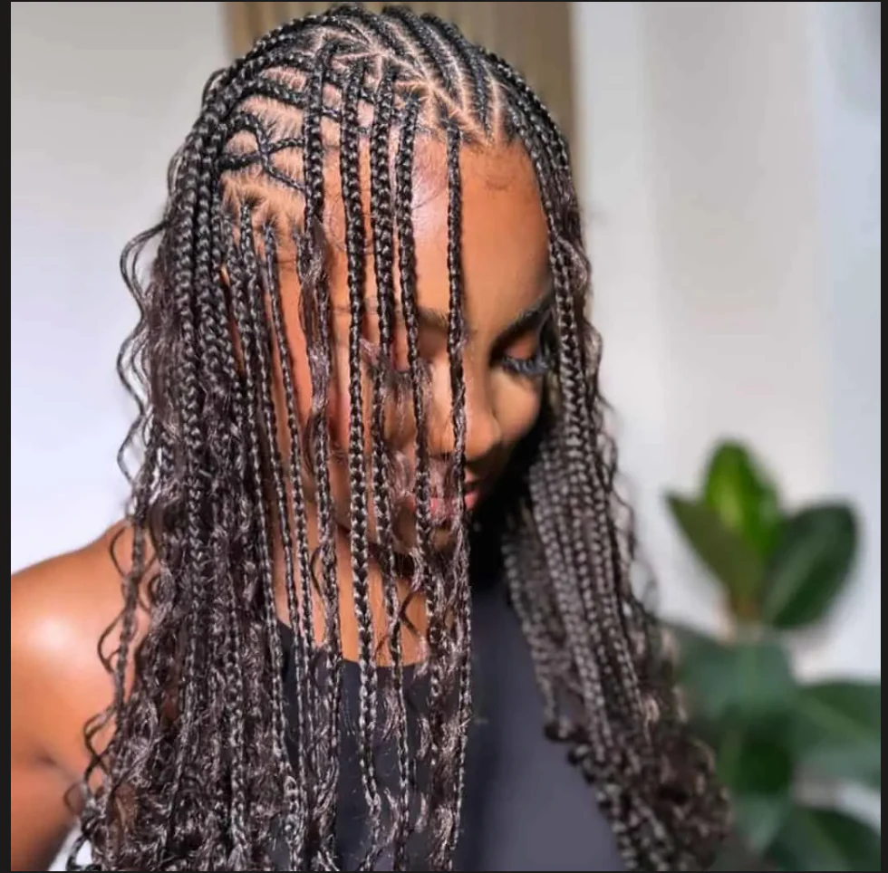 Client wearing Fulani braids with patterned cornrows and loose curled strands